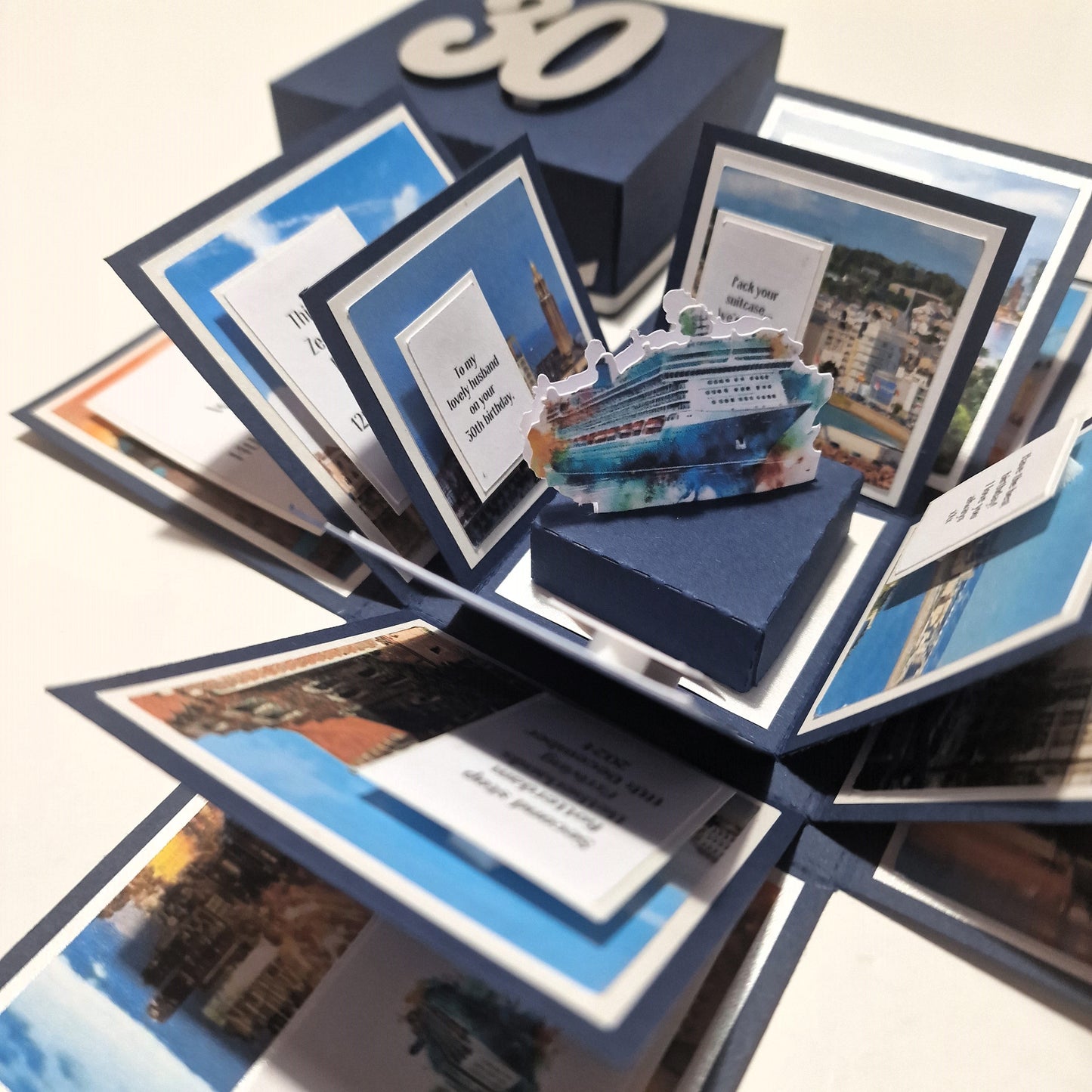 New York - Black & Gold - Surprise Special Occasion | Celebration Trip Reveal Explosion Box features detailed New York-themed panels, a Statue of Liberty centerpiece, and space for personalized trip details.