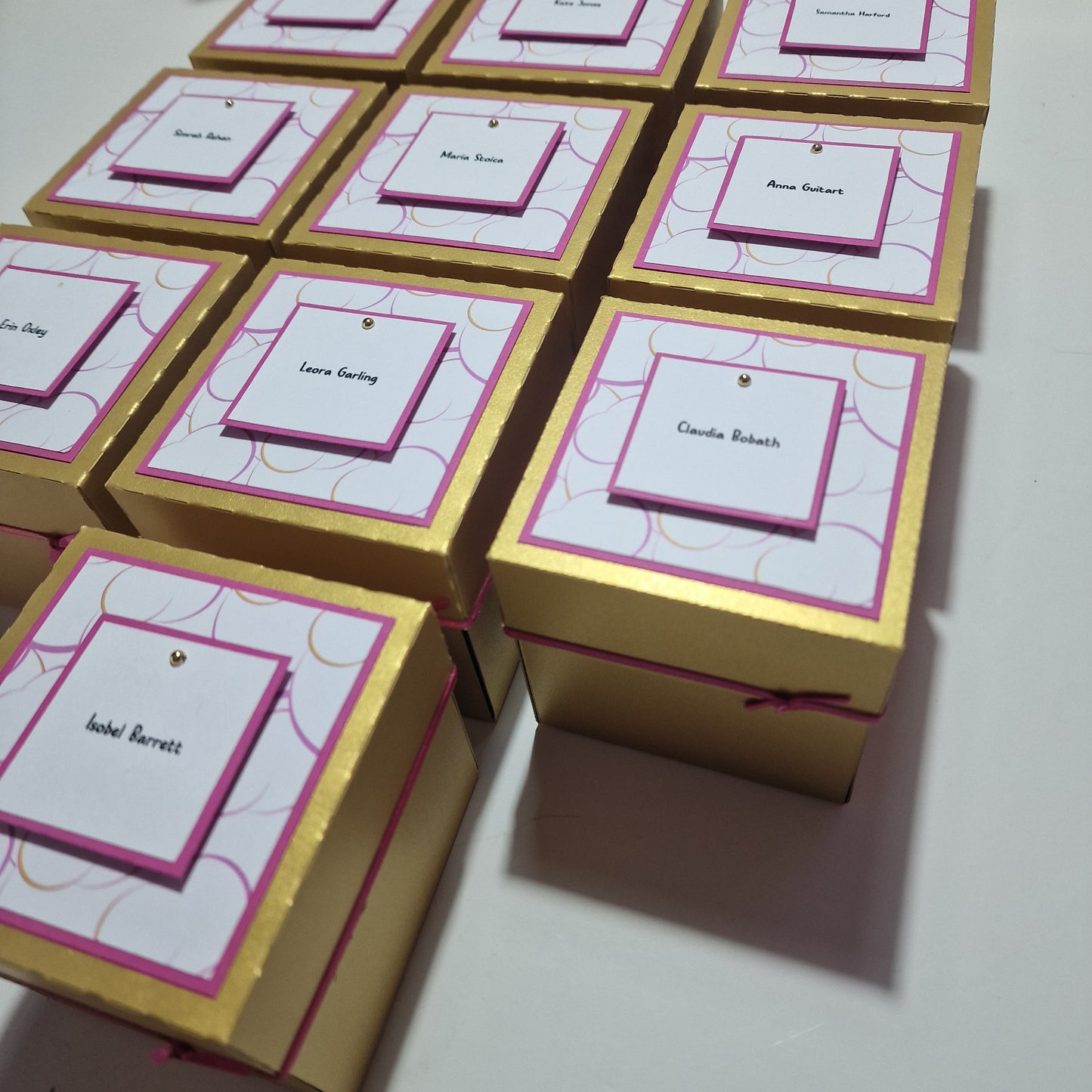 Box'd Disco Themed Invitation Boxes displayed with customizable elements, featuring a gold box with a pink and white design, highlighting the personalized and intricate design options available for unique wedding invitations.