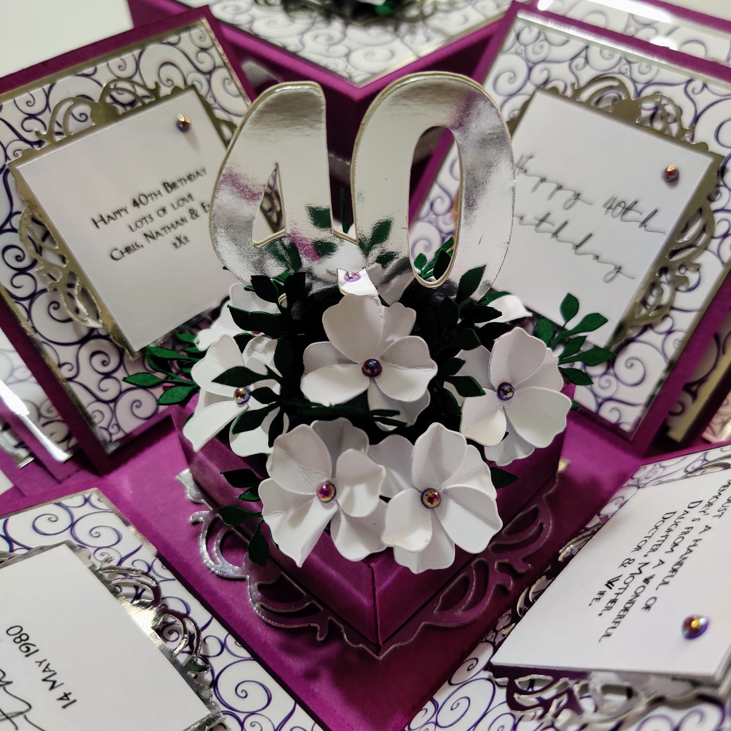 Exploding Memory Photo Box - Purple with Silver Swirls; customizable square box for displaying up to 80 photos, available in various sizes, featuring personalized design options and a unique centerpiece.