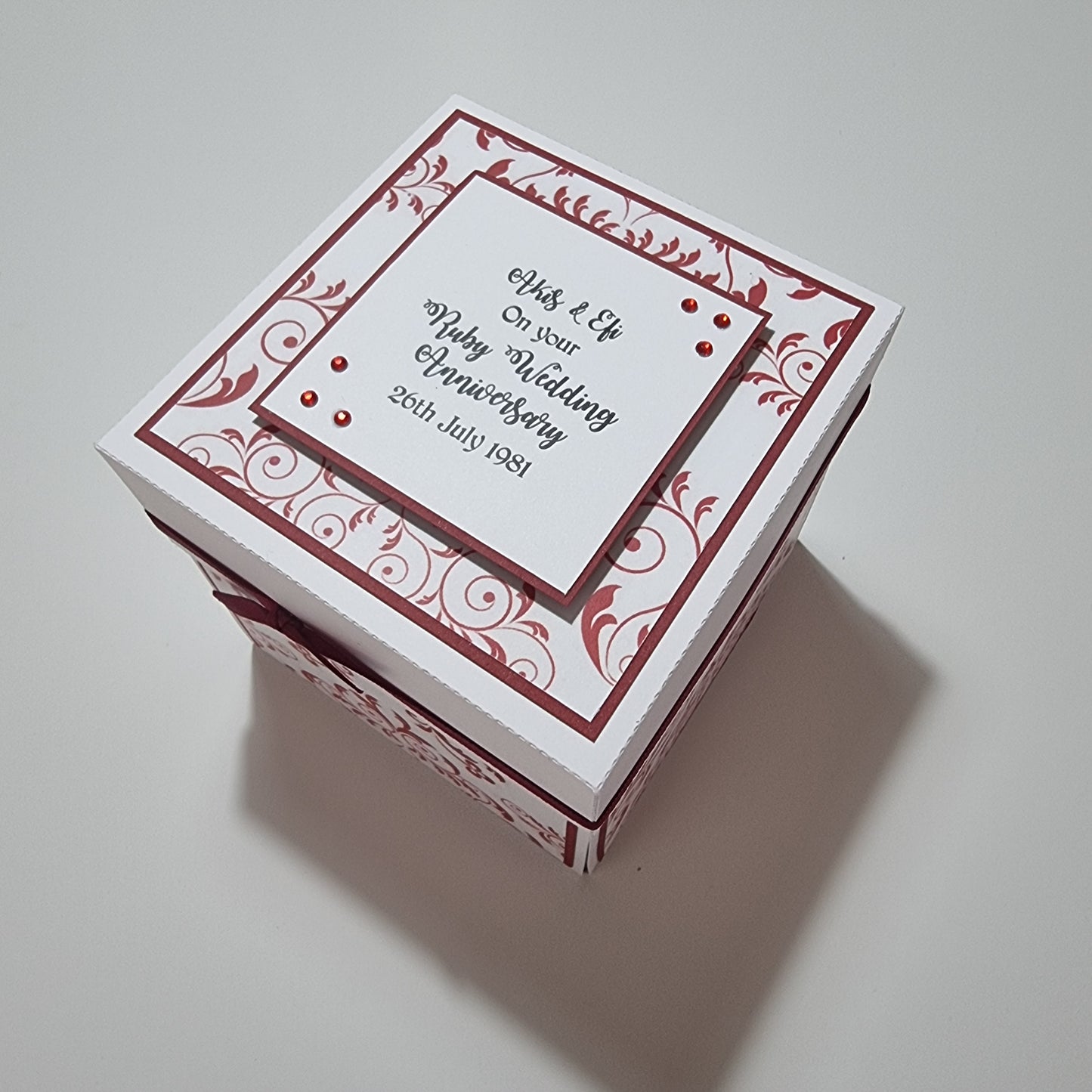 Ruby Wedding Anniversary Exploding Box featuring a white exterior with red and black text. The box is a personalized keepsake, ideal for celebrating a 40th wedding anniversary with heartfelt messages inside.