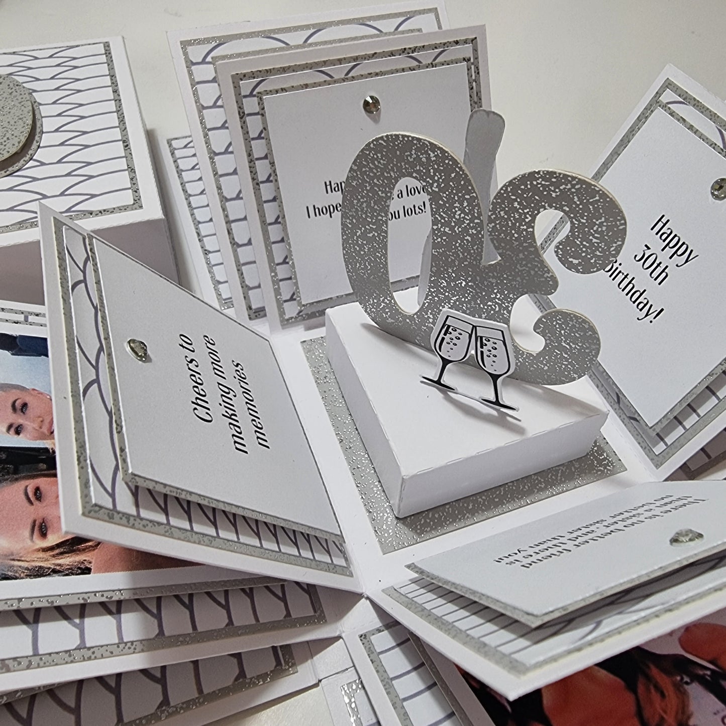 Exploding Memory Photo Box - Silver Scalloped Waves: A handcrafted box with elegant silver wave accents, showcasing photo panels and a 30 champagne centerpiece, designed for milestone celebrations and personalized keepsakes.