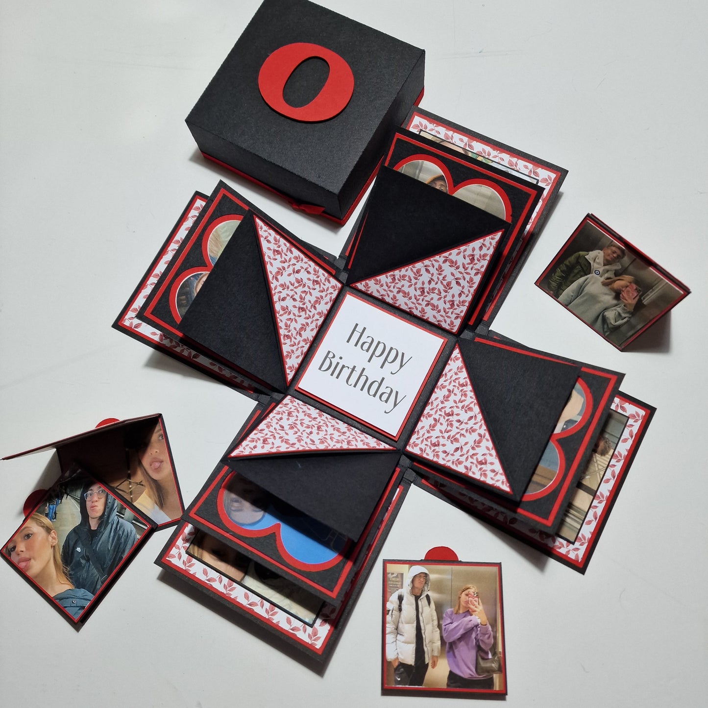 Exploding Memory Photo Box - Black & Red Leaves: A sleek black box with red leaf embellishments unfolds to reveal photo panels and compartments, perfect for preserving cherished memories and celebrating special occasions.