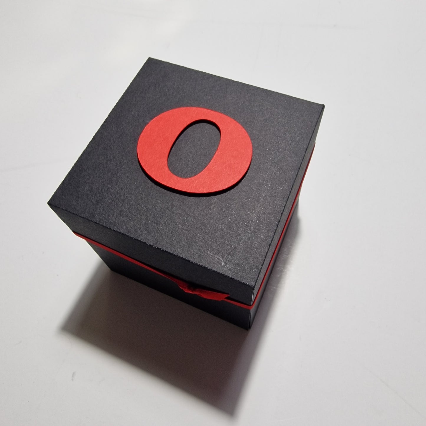 Exploding Memory Photo Box - Black & Red Leaves: A sleek black box unfolds to reveal photo panels and red leaf-patterned embellishments, with a central Happy Birthday sentiment for cherished occasions.