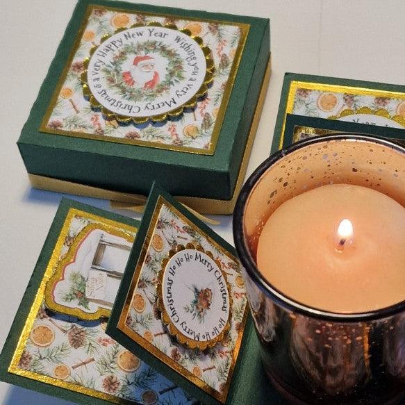 Vintage styled Christmas Candle Box featuring a glass votive candle holder. The box is adorned with festive embellishments, capturing the holiday spirit with elegance and charm. Perfect for gift-giving or decor.