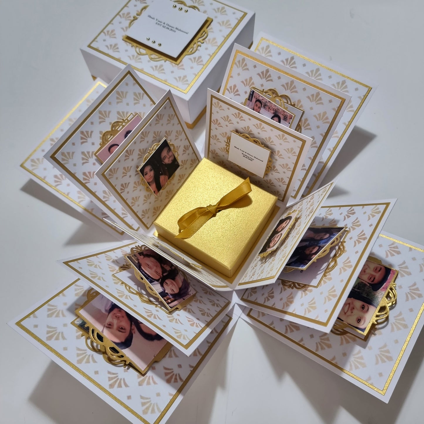 Exploding Memory Photo Box featuring multiple layers with flip albums, pockets, and fold-out flaps, designed as a surprise gift and keepsake album. Available in five sizes, accommodating up to 80 photos.