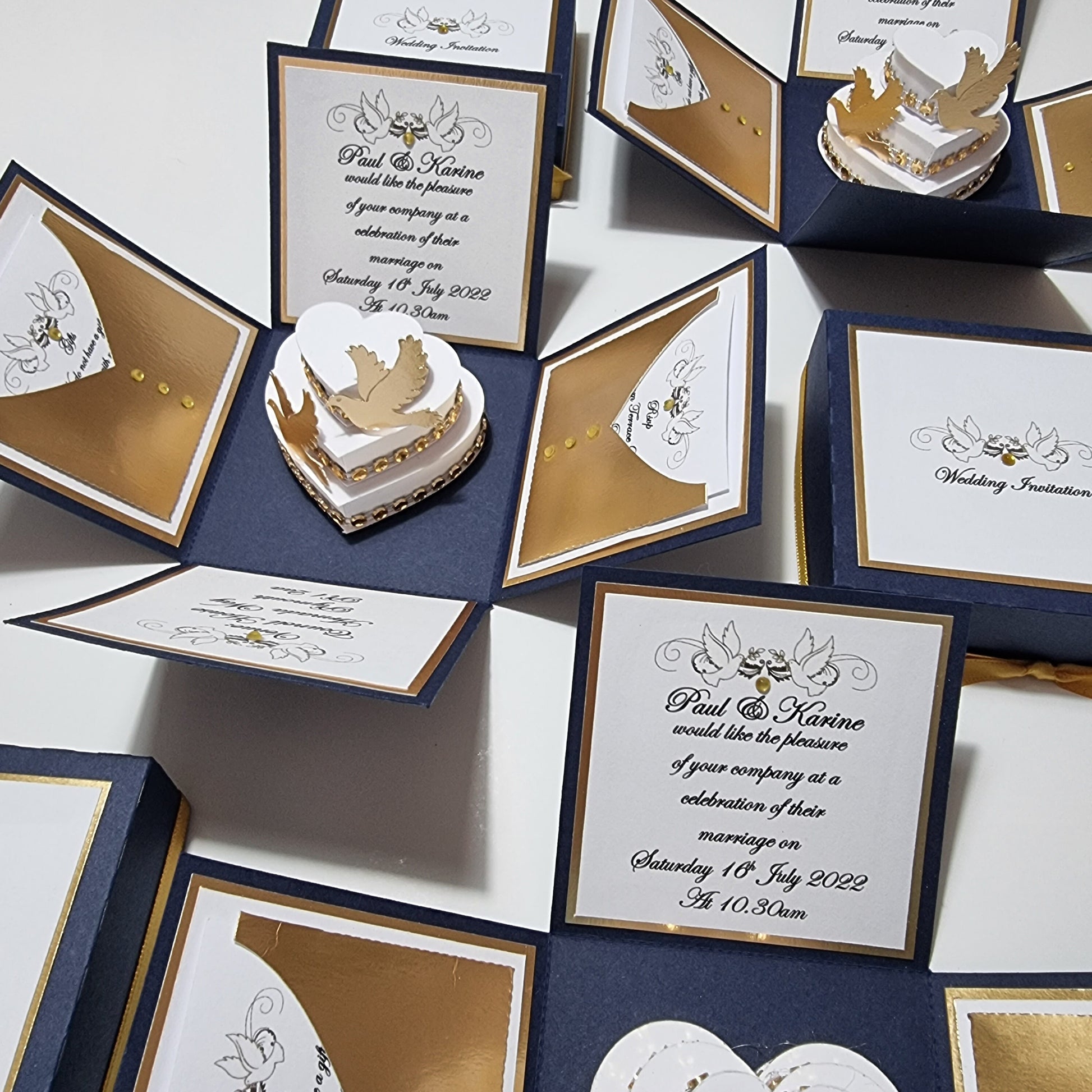 Hearts & Doves Range in Classic Navy Blue and Gold. Unique 3'' Square Exploding Wedding Invitation Box featuring two fixed panels, One with Invitation details and the other with Venue details. Dove & diamante trim details