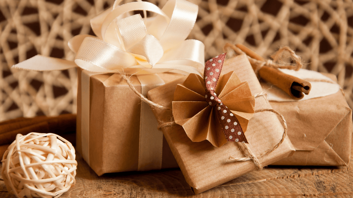 A stack of wrapped presents featuring red and white gift wrap, showcasing a close-up view of festive packaging.