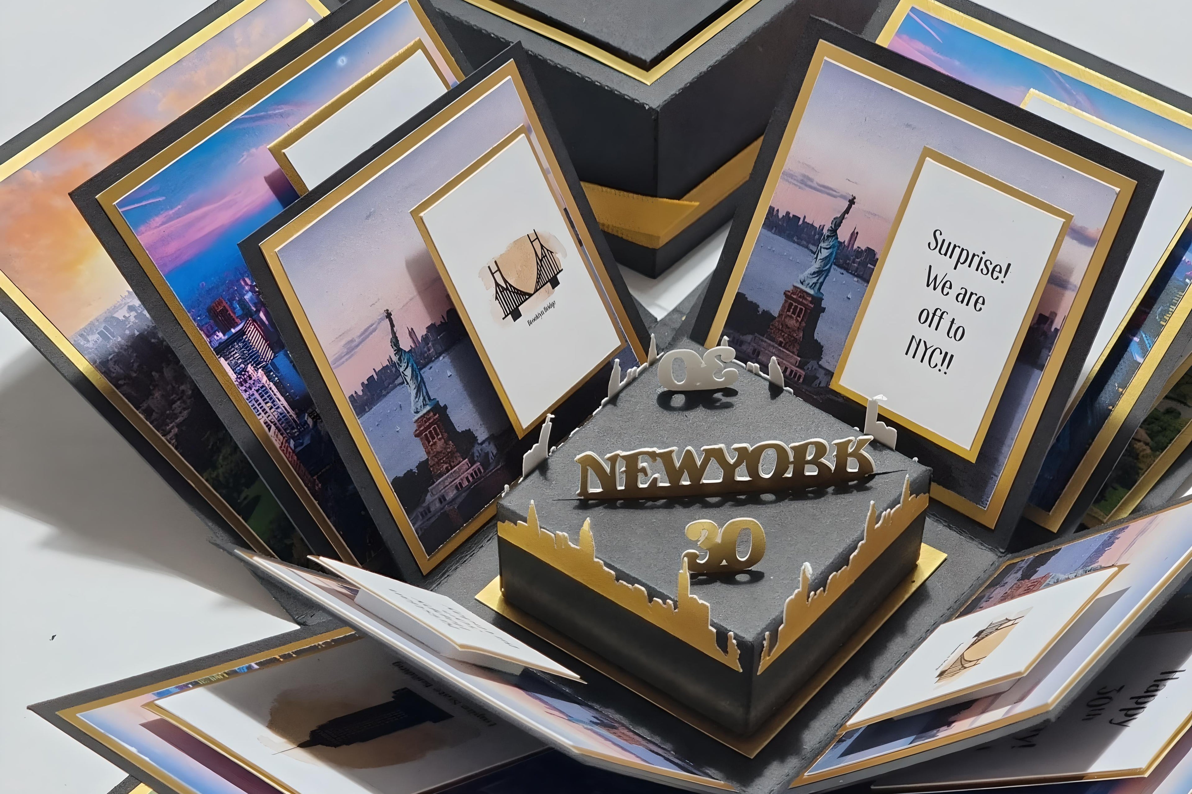 New York - Black & Gold - Surprise Special Occasion | Celebration Trip Reveal Explosion Box featuring iconic New York skyline, Statue of Liberty centerpiece, and themed paper panels inside a decorative box.