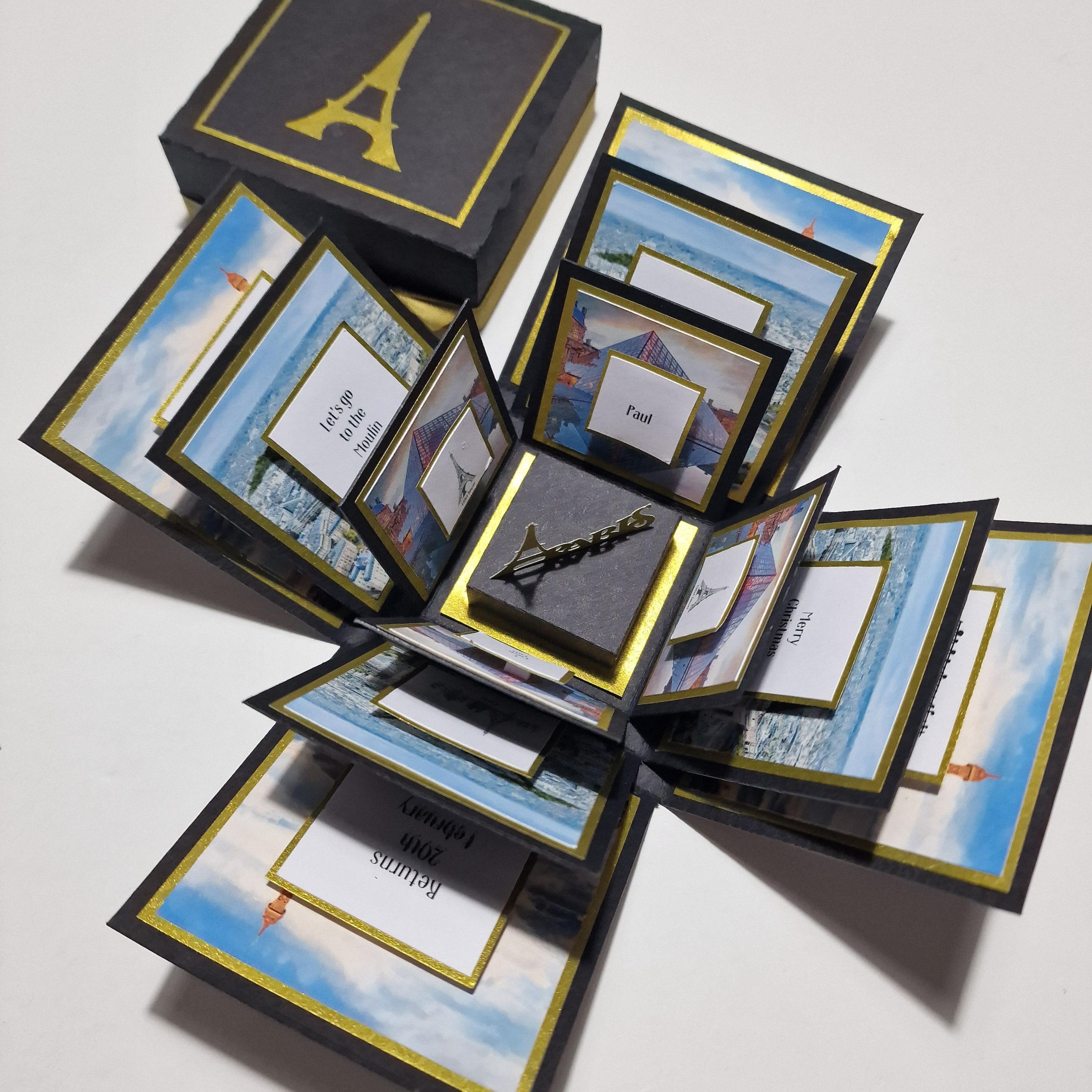 Exploding Occasions Box - Trip Reveal PARIS, featuring a Paris-themed surprise trip box with Eiffel Tower imagery and architectural panels, designed for personalized celebration and gift-giving.