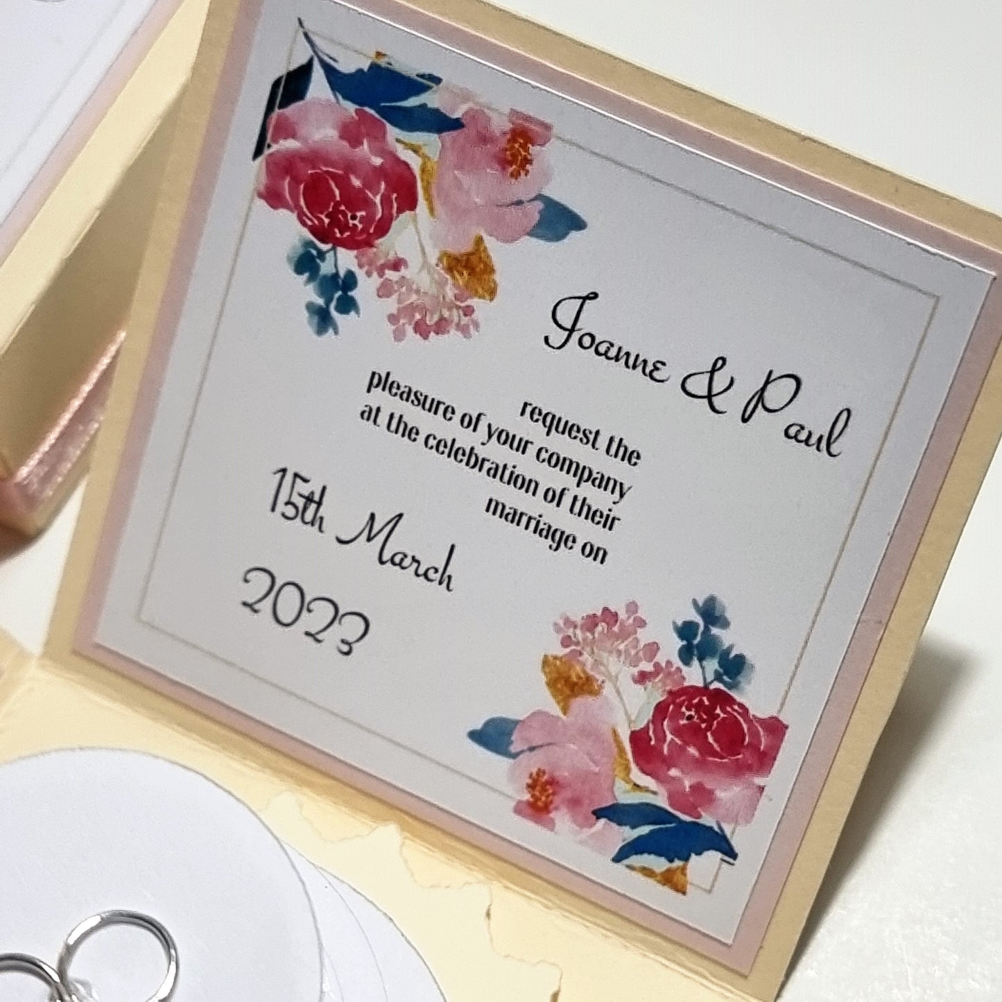 Bohemian Styled Exploding Wedding Invitations do contain a few of the design elements from the Hearts &amp; Doves range however the biggest difference is laid back styling with Central Circular three-tier Wedding cake. The Box is finished off in pastel colours to add a more relaxed feeling. Florals