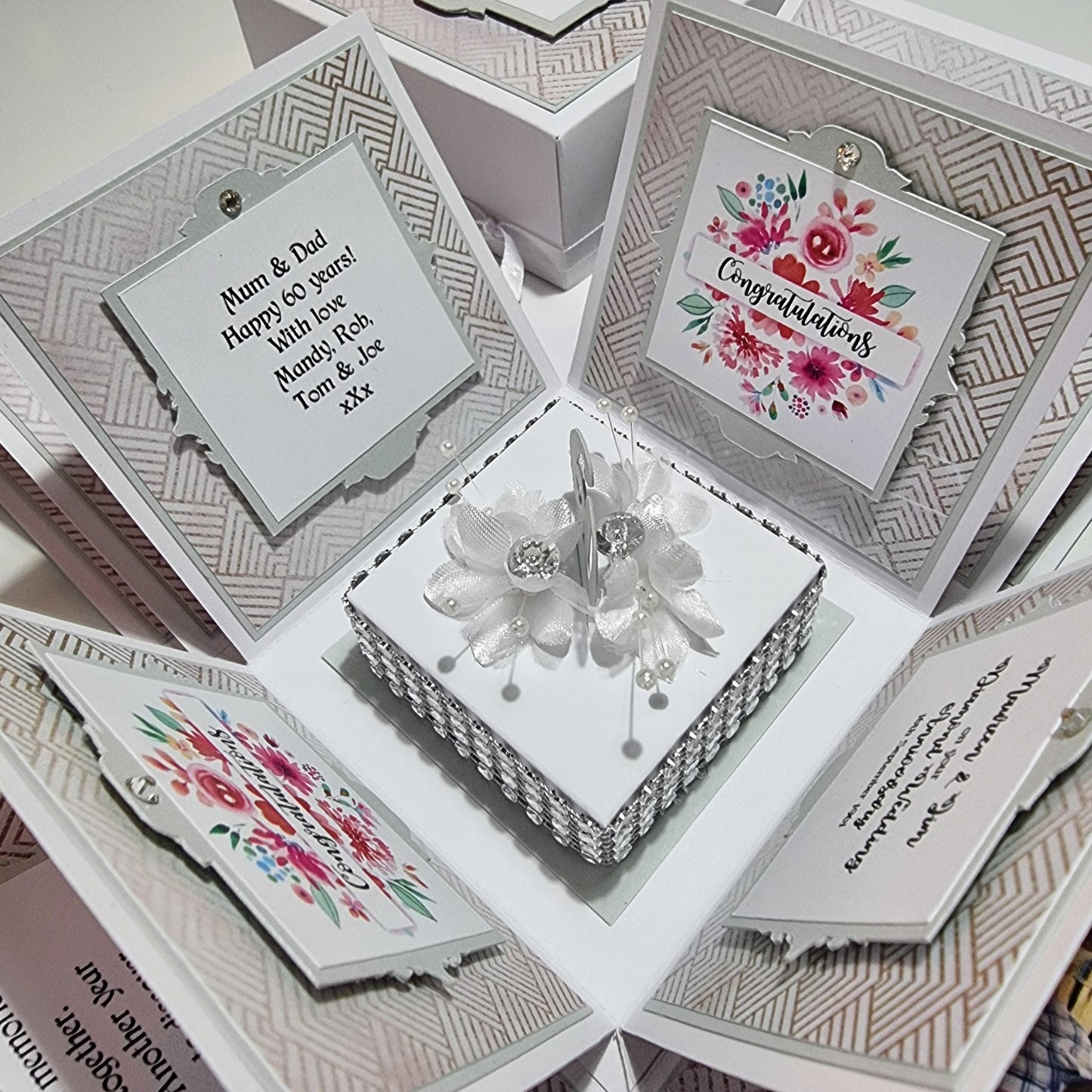 Diamond Wedding Anniversary Exploding Box featuring a white square base with floral and bead designs, unfolding to reveal personalized cards celebrating 60 years of love and commitment.