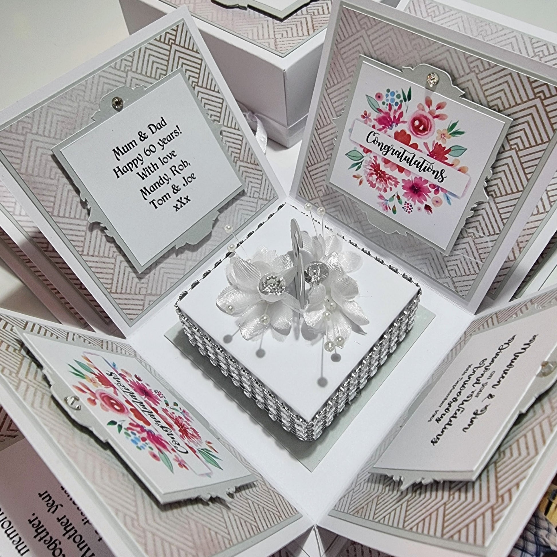 Diamond Wedding Anniversary Exploding Box featuring a white square base with floral and bead designs, unfolding to reveal personalized cards celebrating 60 years of love and commitment.