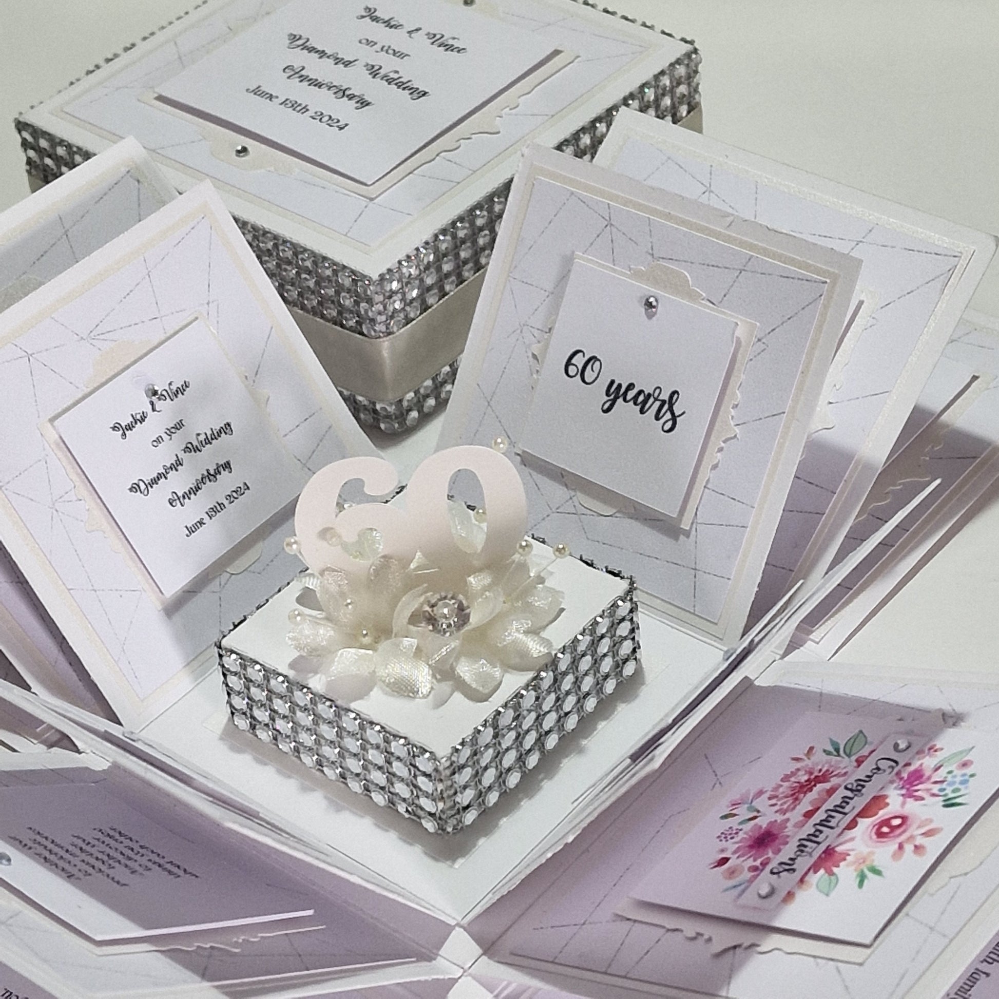 Diamond Wedding Anniversary Exploding Box featuring a white square design with diamond accents, personalized panels, and a ribbon, celebrating 60 years of love with elegant, layered surprises.