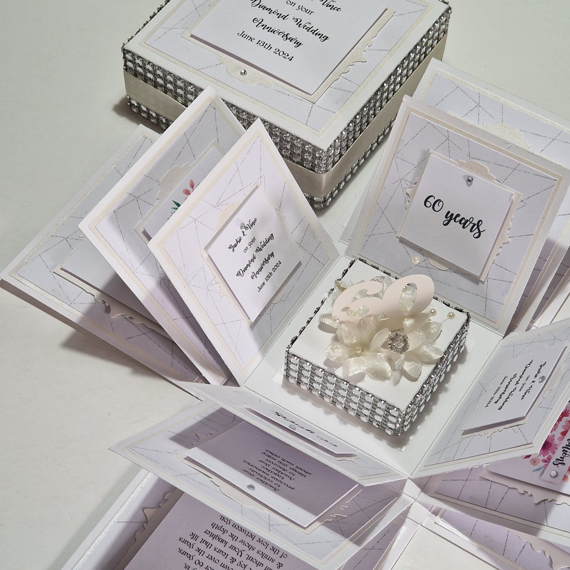 Diamond Wedding Anniversary Exploding Box with floral and diamond-inspired design, featuring personalized messages inside. A unique keepsake celebrating 60 years of marriage, crafted from white cardstock with pearlescent mounts.