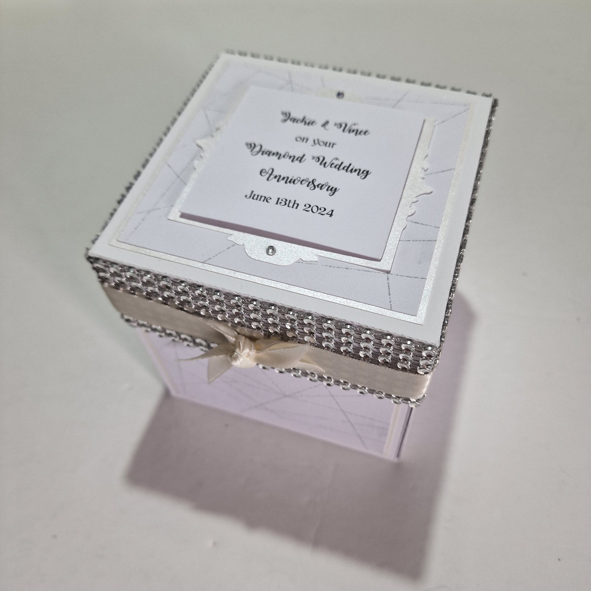 Diamond Wedding Anniversary Exploding Box featuring a white box with a ribbon and card, crafted from cardstock, offering customizable personal messages and anniversary-themed designs for a memorable keepsake.