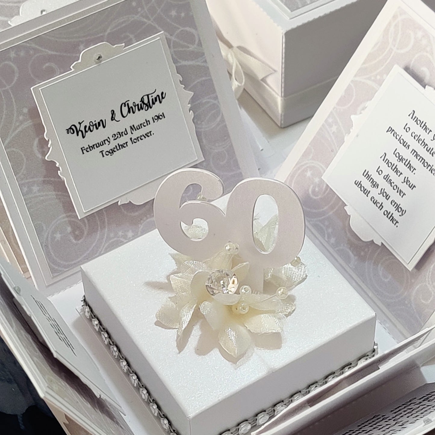 Diamond Wedding Anniversary Exploding Box with a white base and pearlescent panels, featuring diamond-inspired accents and customizable layers for personalized messages and surprises, perfect for celebrating 60 years together.