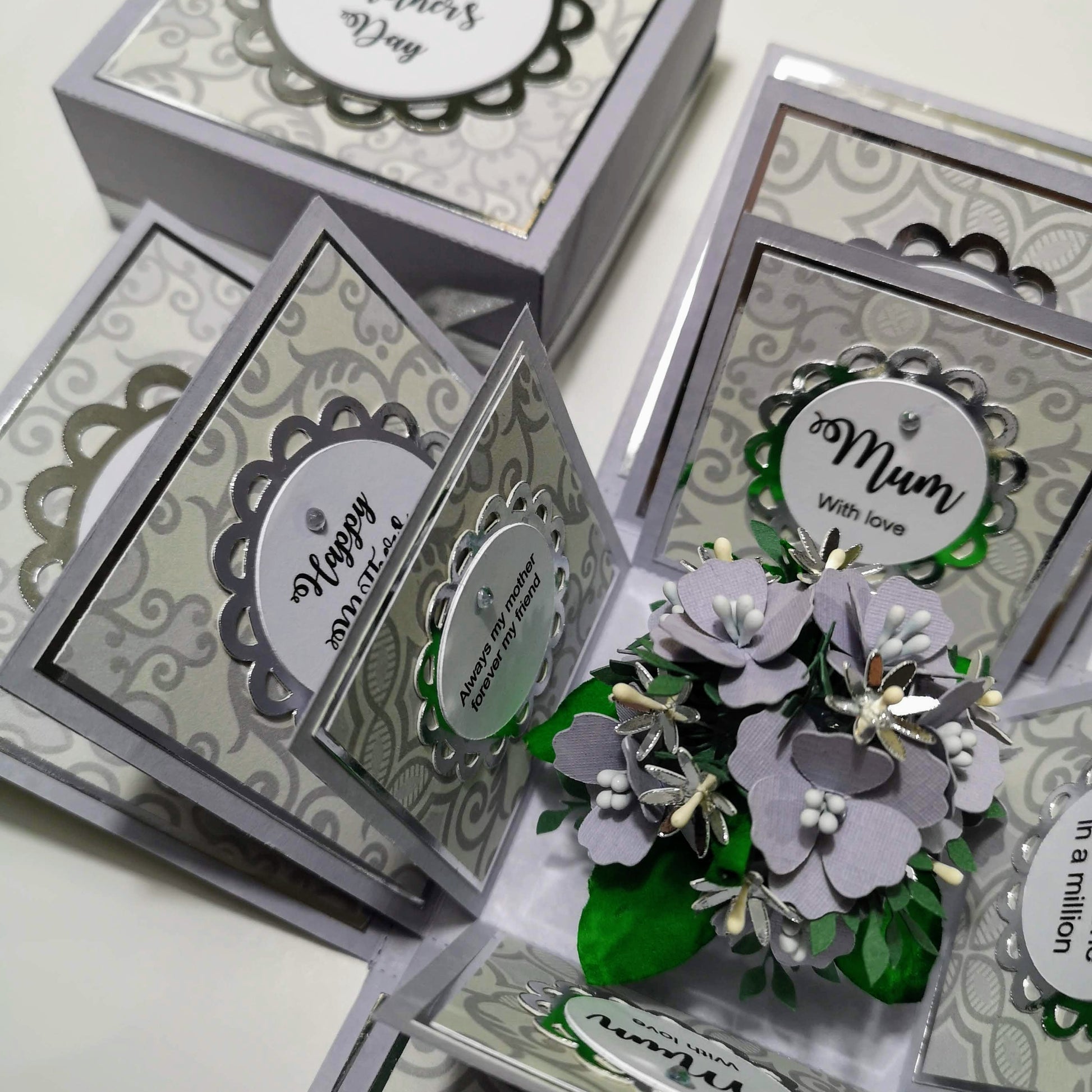 Mother's Day Forever Flower Bouquet Explosion Gift features a pop-open card with a lifelike floral arrangement in a decorative box, creating a surprise element for special occasions.