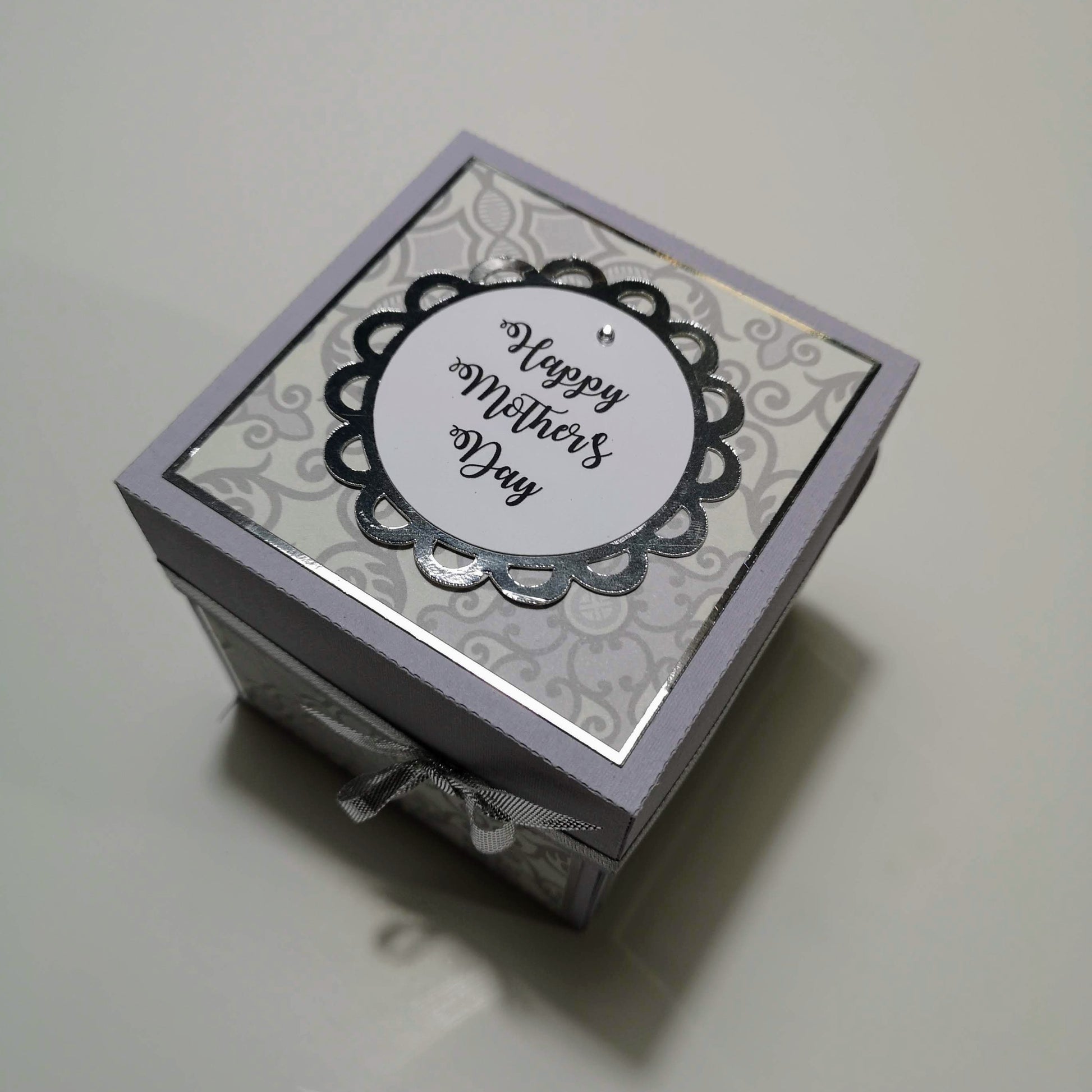 Mother's Day Forever Flower Bouquet Explosion Gift | Celebration Gift Box Pop Open Card featuring a ribbon-tied box with intricately crafted pop-open panels and three-dimensional floral arrangement inside.
