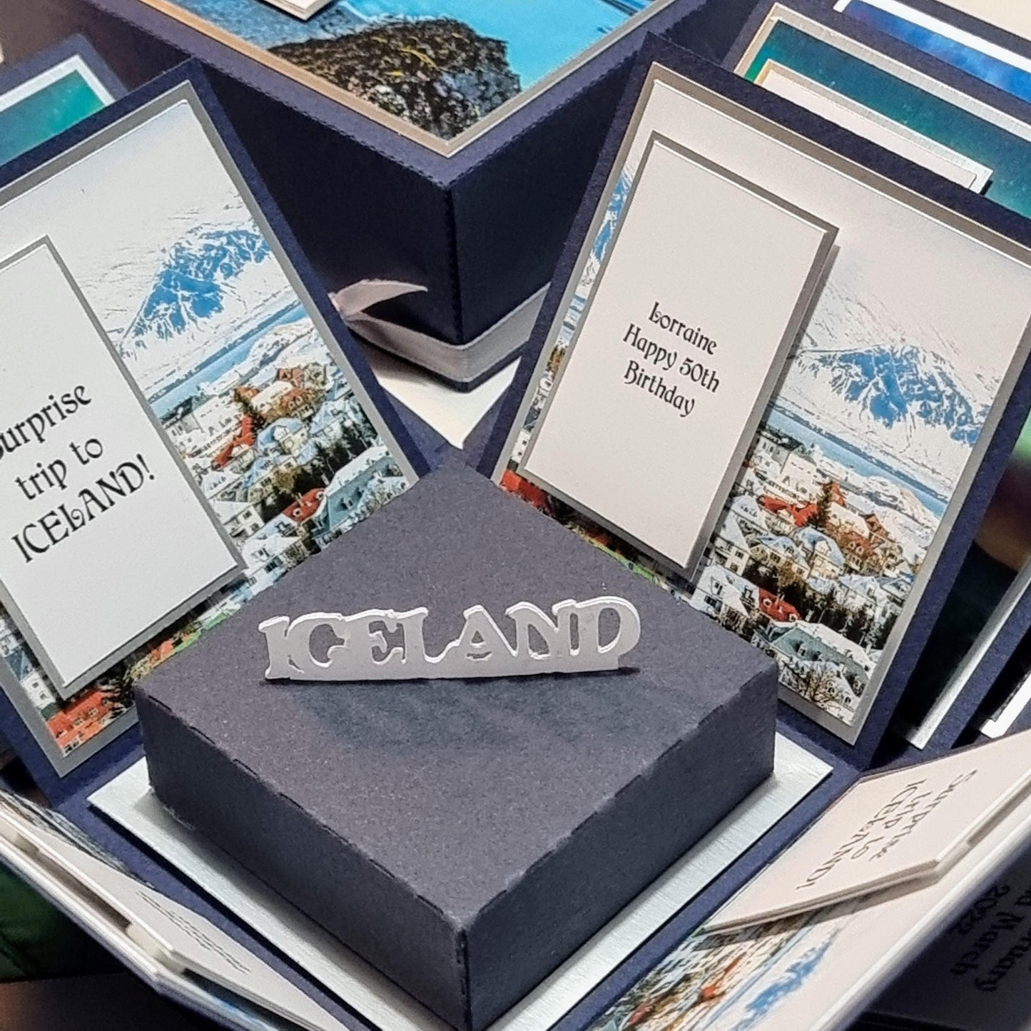 Exploding Occasions Box - Trip Reveal ICELAND: A decorative box featuring Iceland-themed paper and verse panels, designed to reveal a surprise trip with personalized details included.