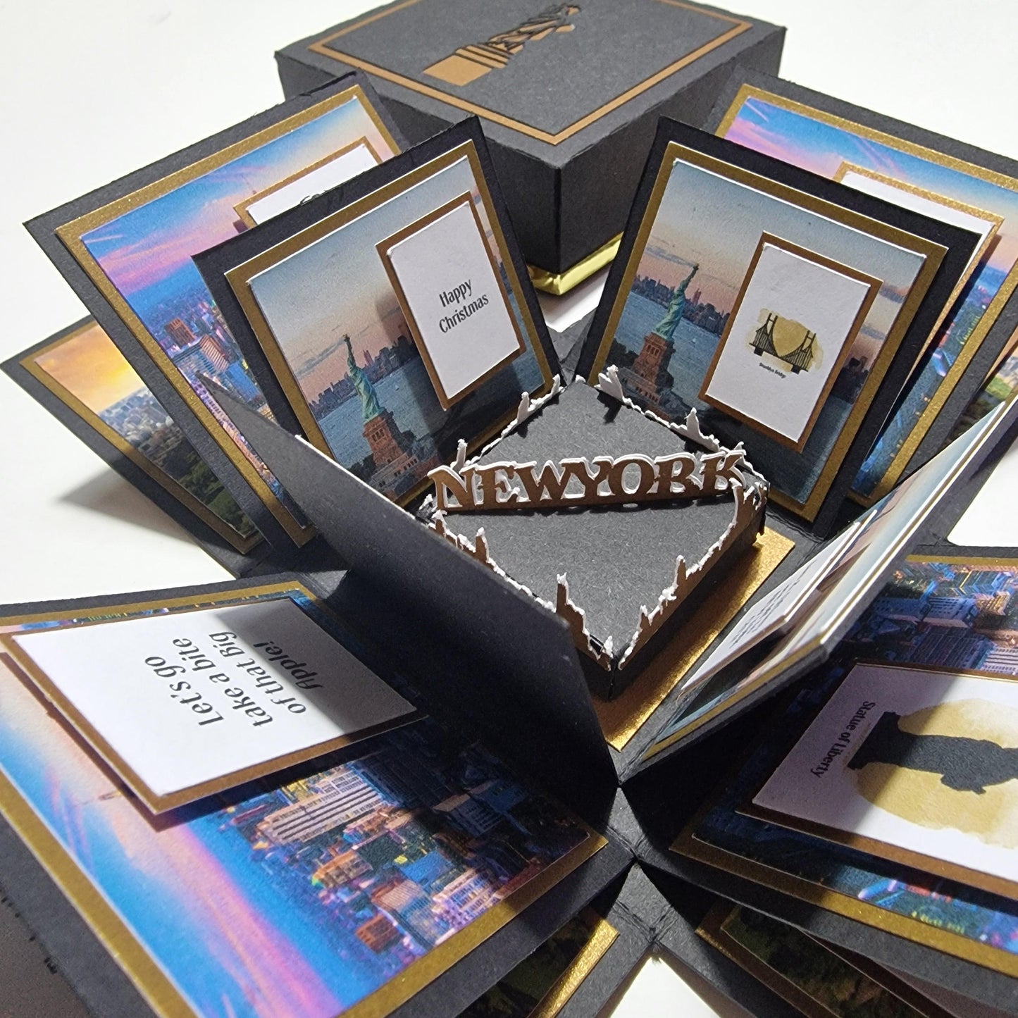 Exploding Occasions Box - Trip Reveal NEW YORK, featuring a freestanding Statue of Liberty, New York skyline, and themed panels inside a black box with gold trim and city imagery.