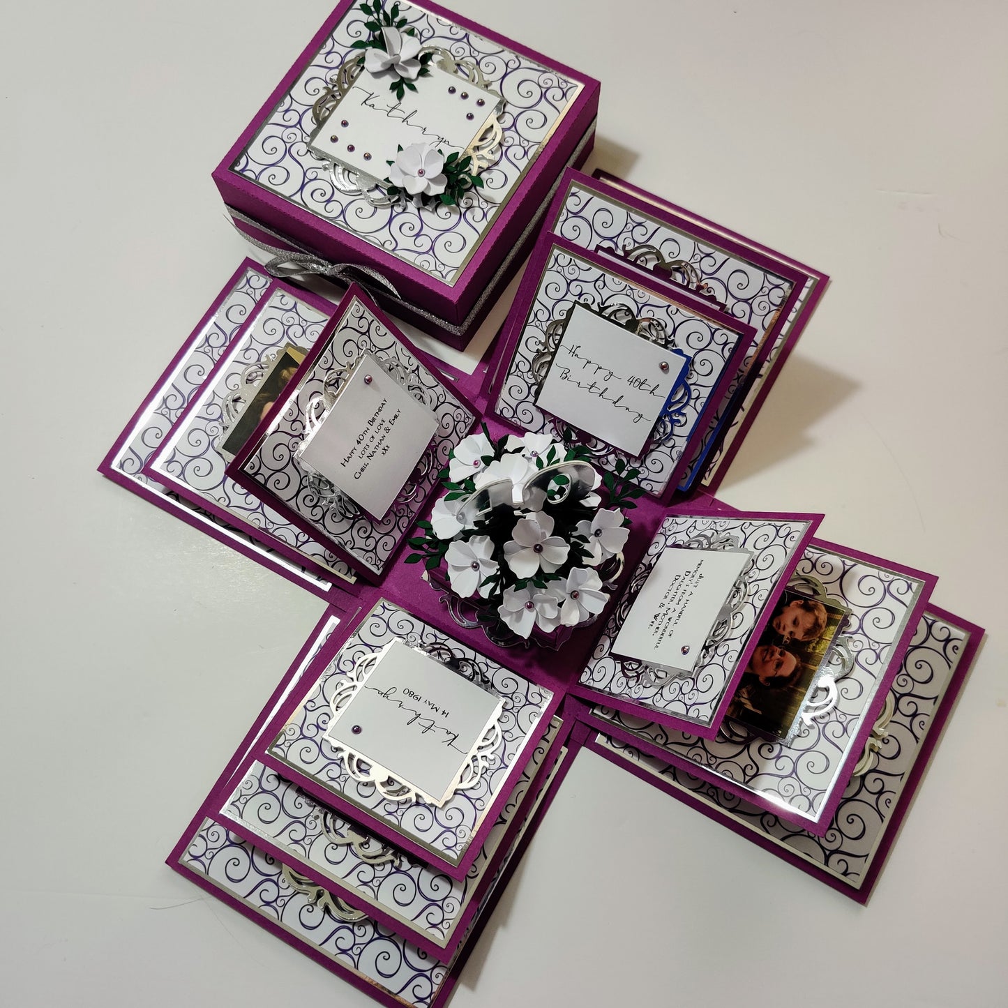 Exploding Memory Photo Box - Purple with Silver Swirls, showcasing customizable panels for photos, with a central compartment for a gift or photo cube, designed to display up to 80 photos.