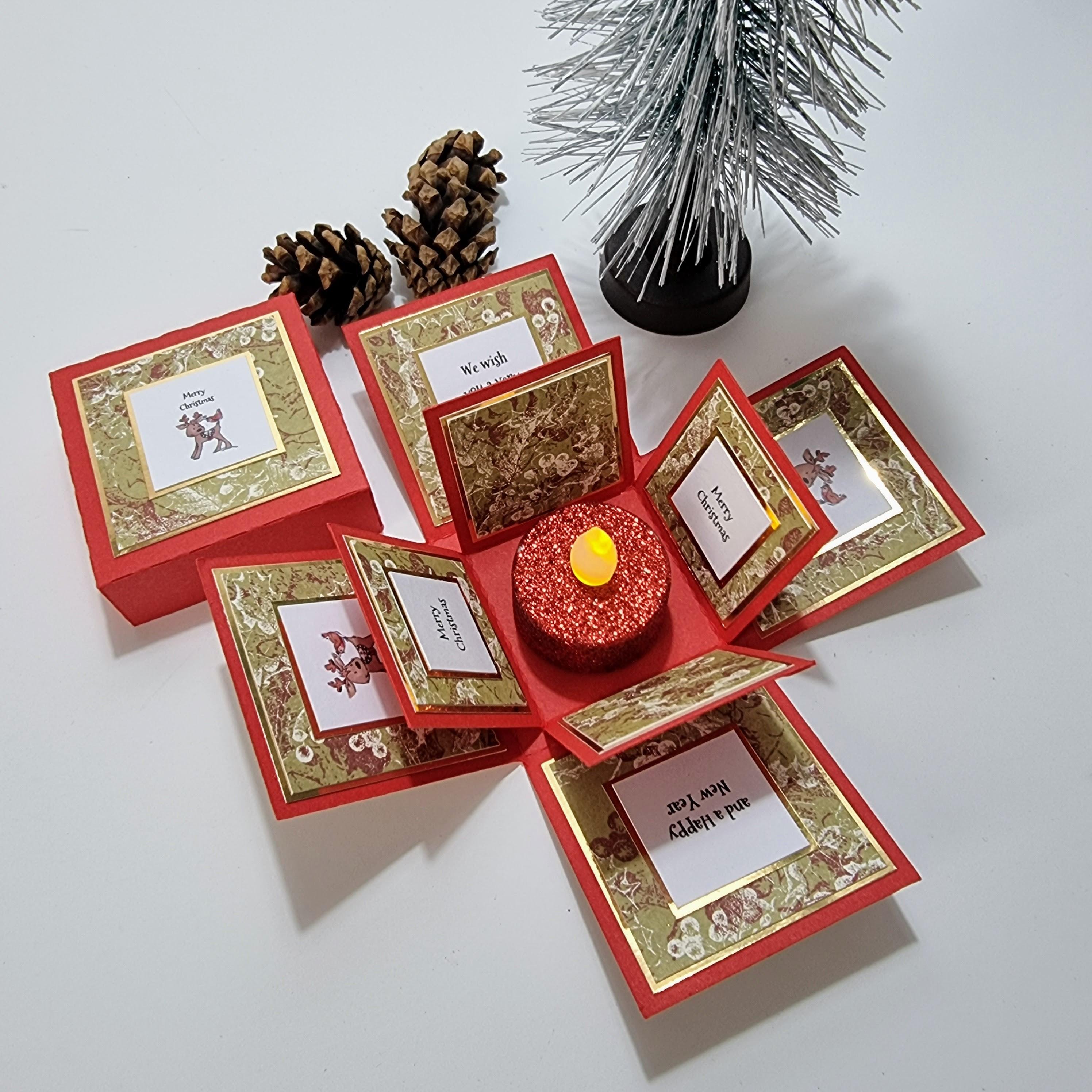 Rudy the Reindeer Christmas Box Card features a reindeer in festive attire inside a red and gold-accented box, accompanied by a Merry Christmas greeting, ideal for personalized holiday messages.