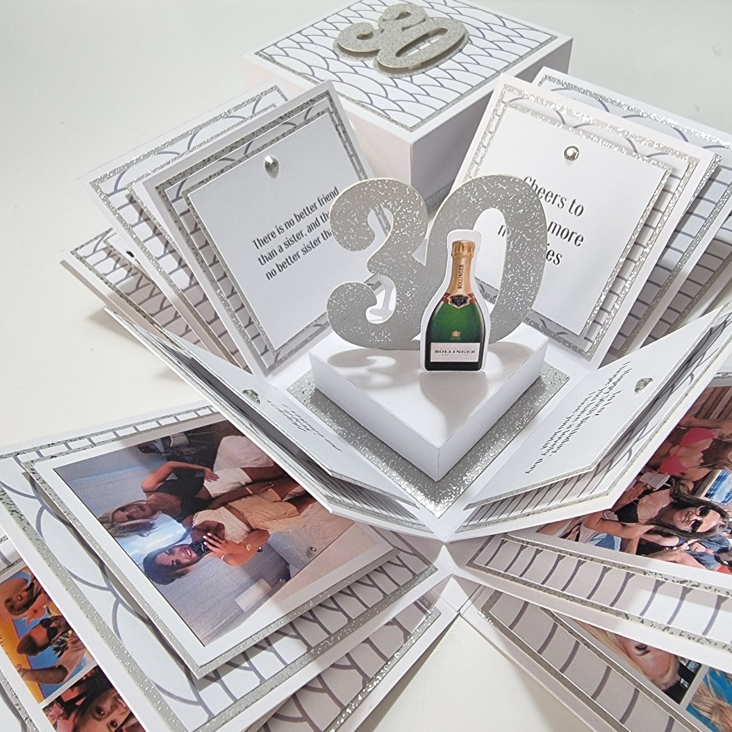 Exploding Memory Photo Box - Silver Scalloped Waves: A handcrafted box with silver accents, unfolds to reveal arranged photo panels and a 30 centerpiece with a champagne bottle cutout, celebrating milestones.