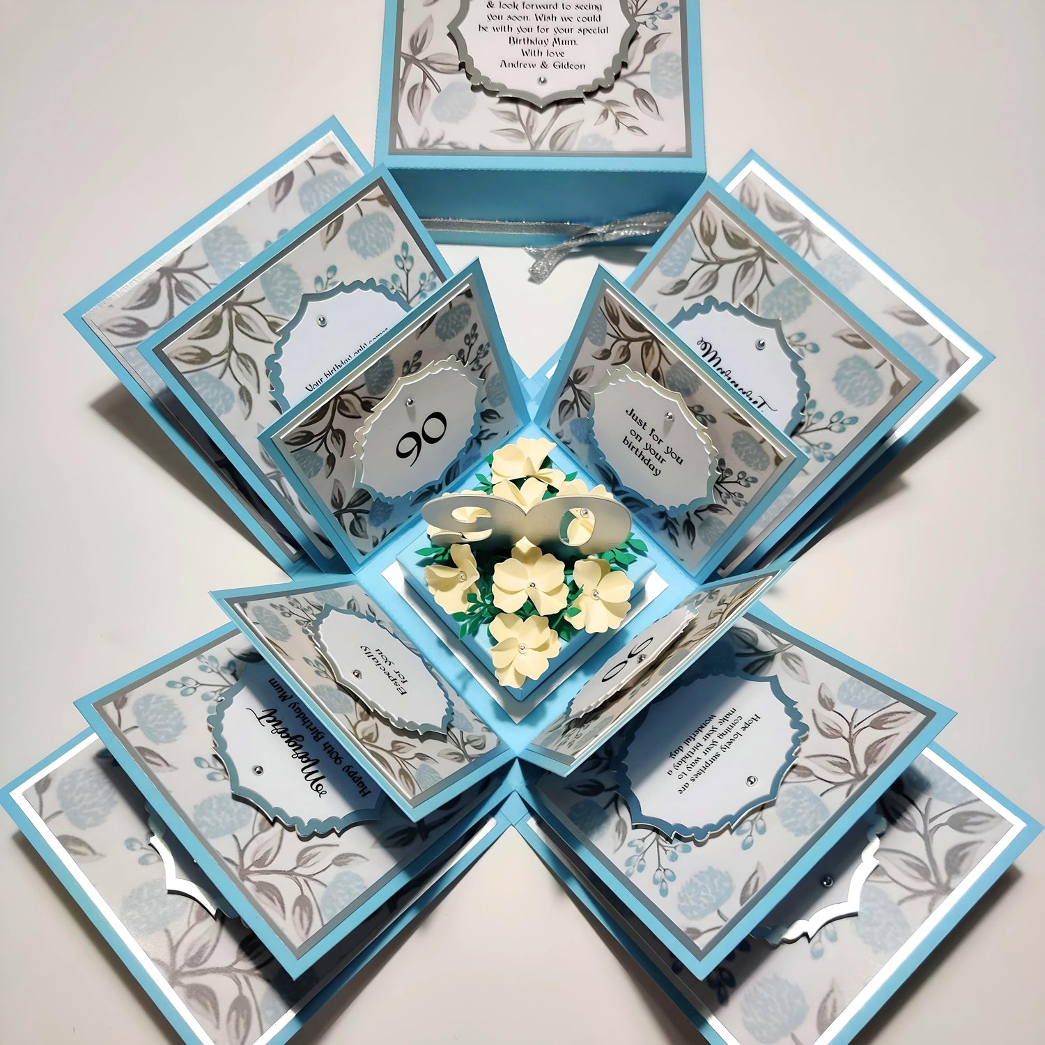 Sky Blue Exploding Birthday Celebration Box with Dove Grey accents & Cream Forget Me Knot Flowers