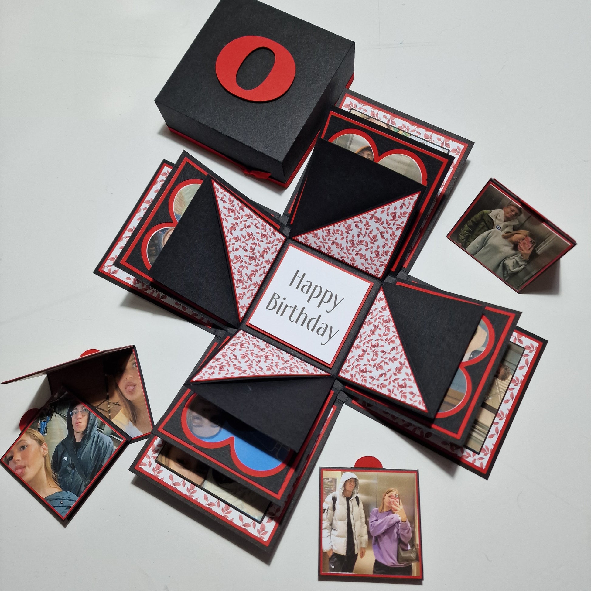 Exploding Memory Photo Box - Black & Red Leaves: A sleek black box with red leaf embellishments unfolds to reveal photo panels and compartments, perfect for preserving cherished memories and celebrating special occasions.