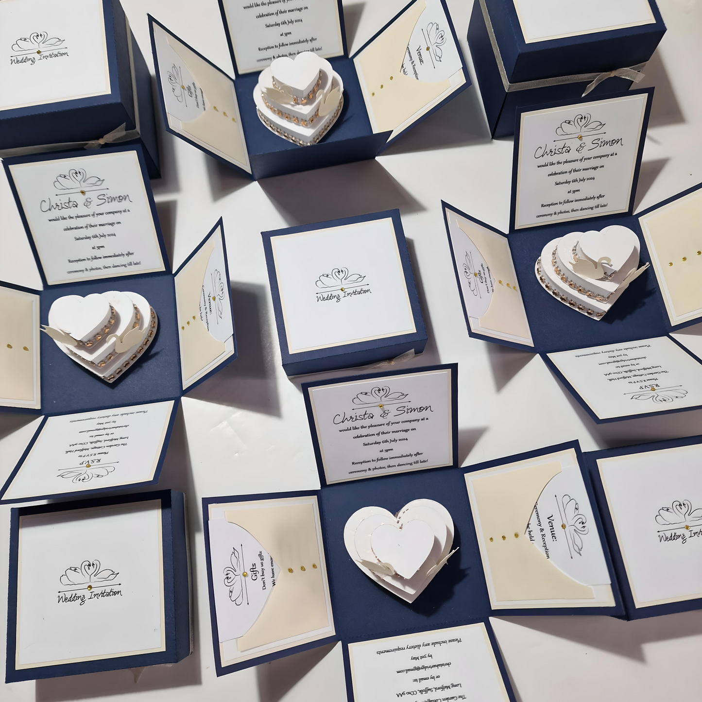 Swans Pocket Exploding Wedding Invitation Boxes featuring heart-shaped cake with swans, elegant cards, and detailed panels for wedding details and RSVP, creating a memorable keepsake.