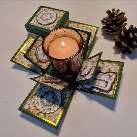 Vintage styled Christmas Candle Box featuring a green box with gold accents, housing a glass holder with a Christmas-scented votive candle, designed for festive decor or thoughtful gifting.